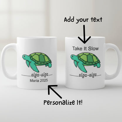 Two white mugs with green turtles and text on a white background