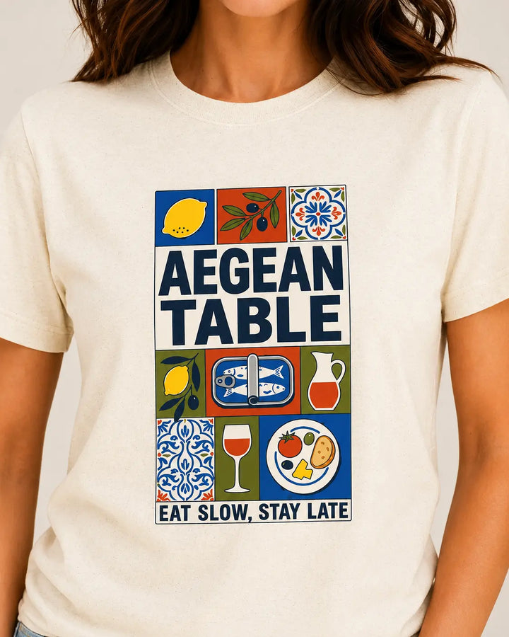 TP HERO: Person wearing a t-shirt with 'Aegean Table' design featuring food and drink icons.