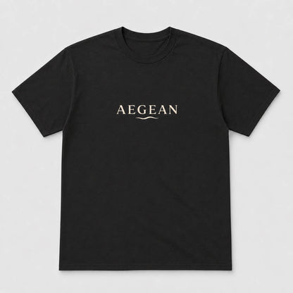 A black short-sleeve crewneck t-shirt with the word 'AEGEAN' printed in a light beige serif font across the chest, accompanied by a small wave graphic underneath, shown on a light gray background.