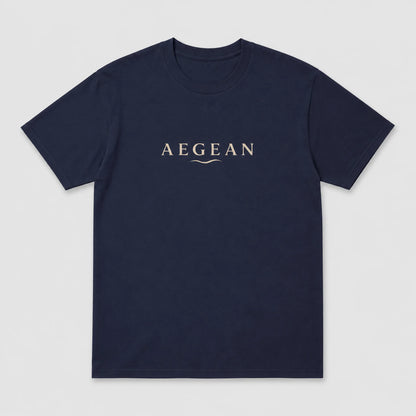 A navy blue short-sleeve crewneck t-shirt with the word 'AEGEAN' printed in a light beige serif font across the chest, accompanied by a small wave graphic underneath, shown on a light gray background.