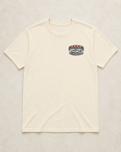 An off-white crewneck t-shirt with a small multicolor graphic on the left chest, laid flat against a light beige textured background.