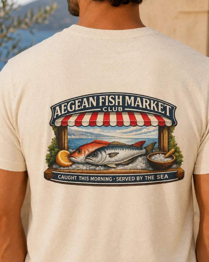 Model wearing a natural Aegean Fish Market Club T-shirt with a large vintage fish market back print.