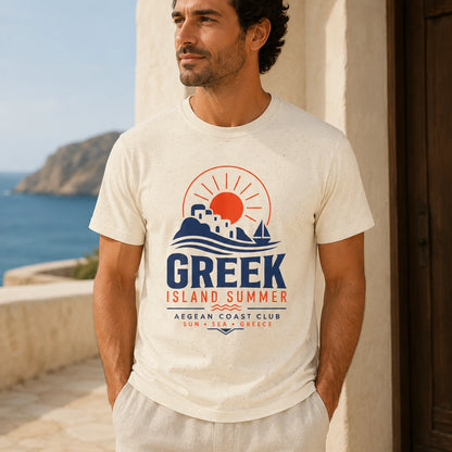 Man wearing a 'Greek Island Summer' t-shirt with a scenic design, standing by a coastal building.