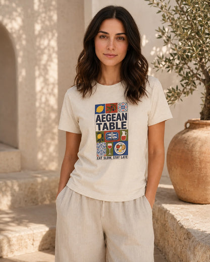 Woman wearing a 'Grecian Table' t-shirt in an outdoor setting.