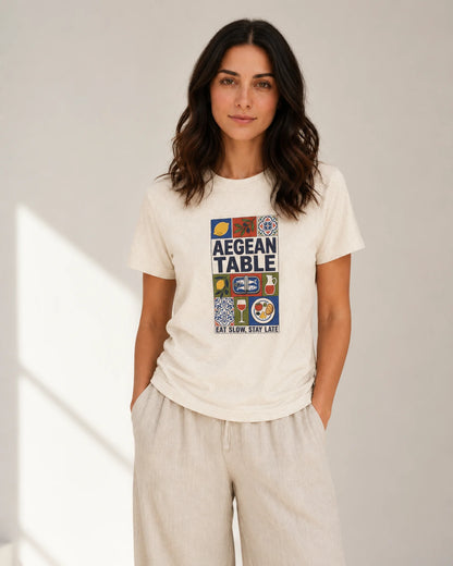 Woman wearing a white t-shirt with colorful graphics and text on a plain background