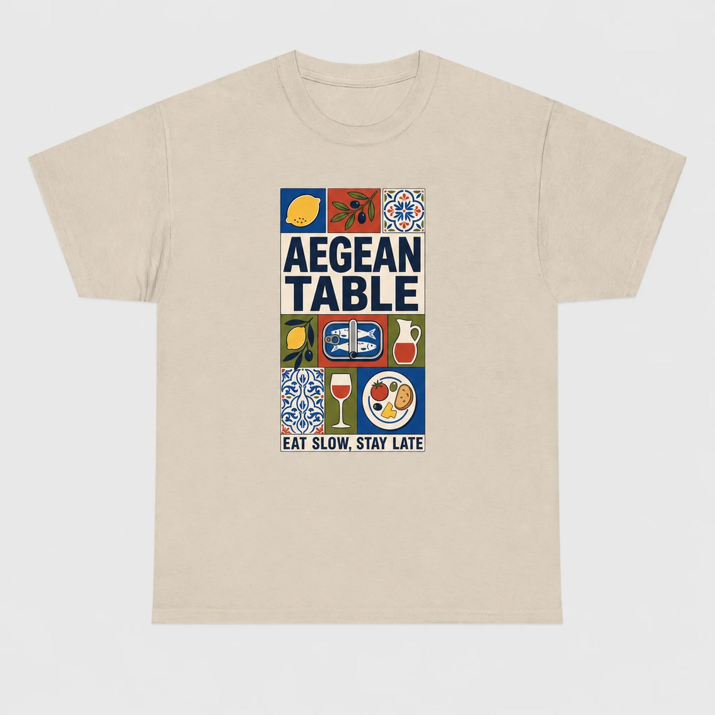 Beige t-shirt with 'Aegean Table' graphic design on a white background
