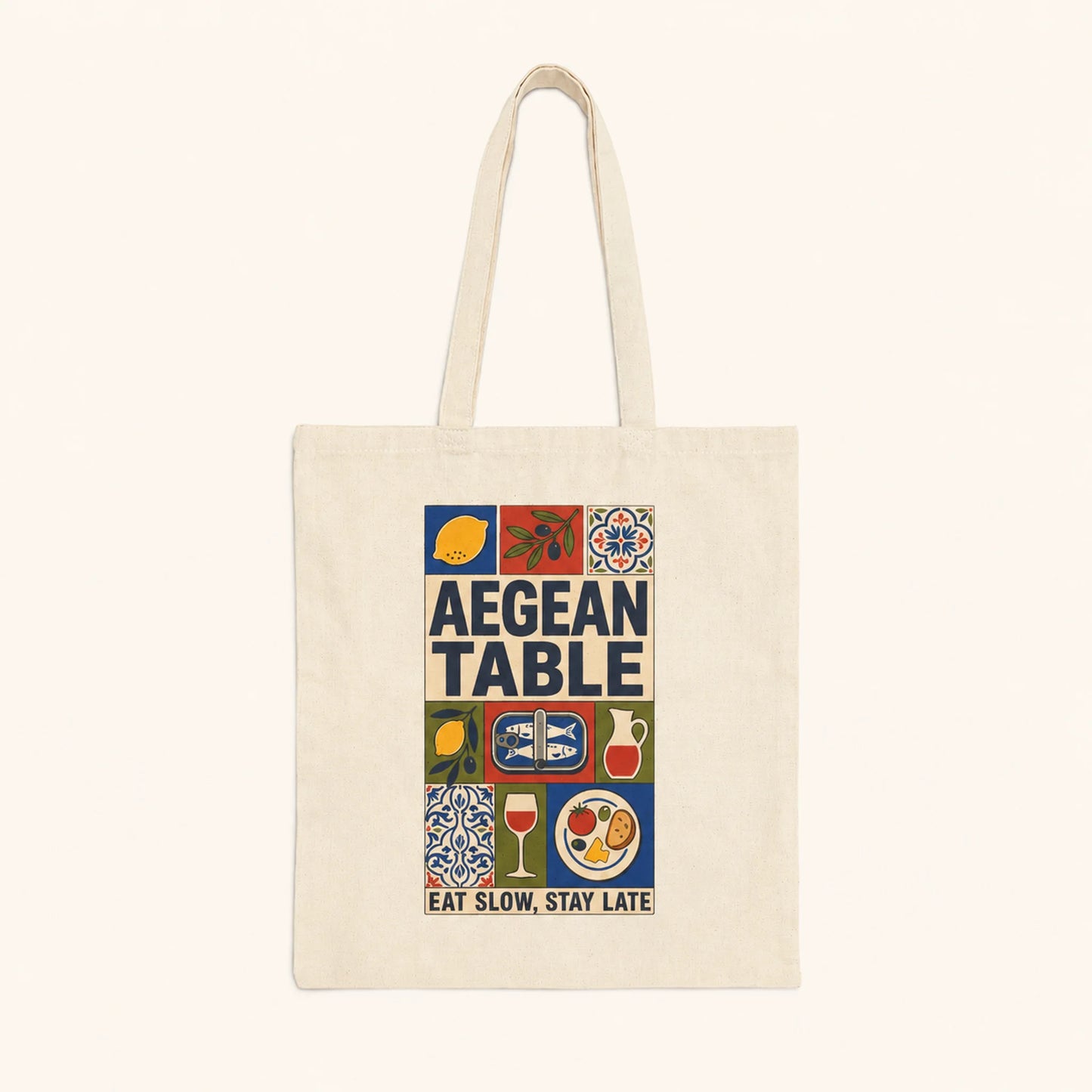Tote bag with 'Aegean Table' design featuring food icons and text on a white background