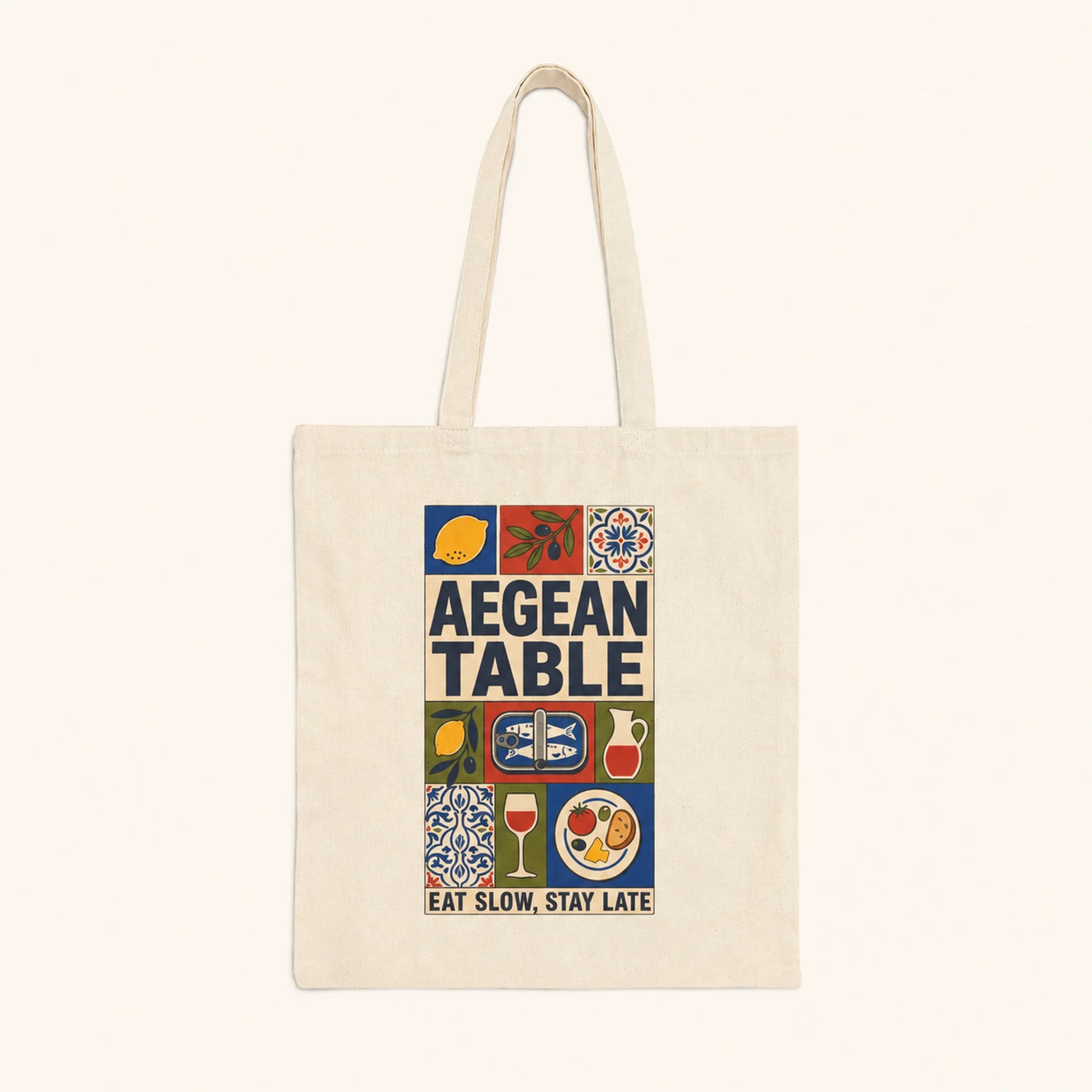 Tote bag with 'Aegean Table' design featuring food icons and text on a white background