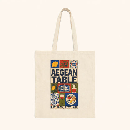 Tote bag with 'Aegean Table' design featuring food icons and text on a white background