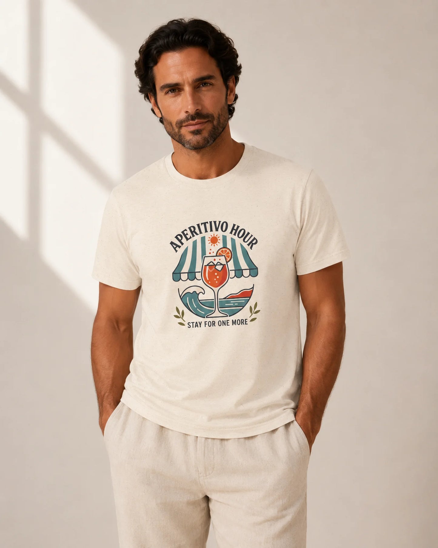 Man wearing a white t-shirt with a graphic design and text, standing against a neutral background
