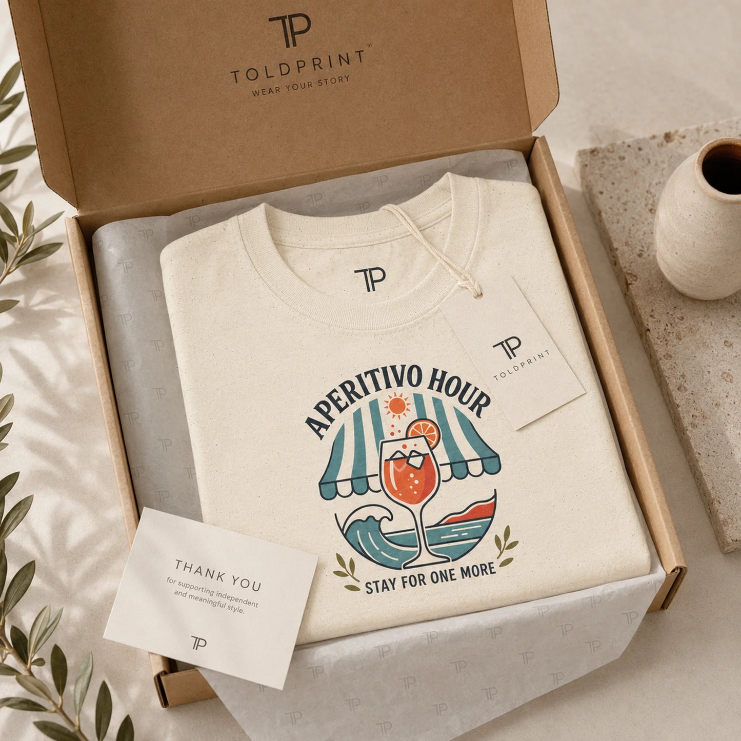 Beige hoodie with 'Aperitivo Hour' design in a Toldprint box.