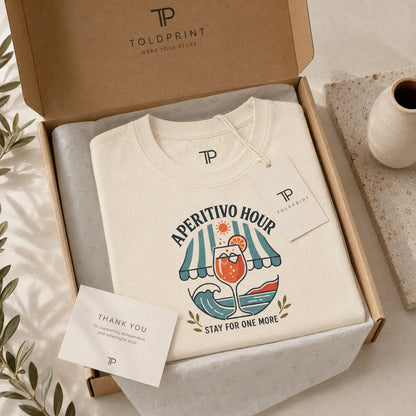 Beige hoodie with 'Aperitivo Hour' design in a Toldprint box.