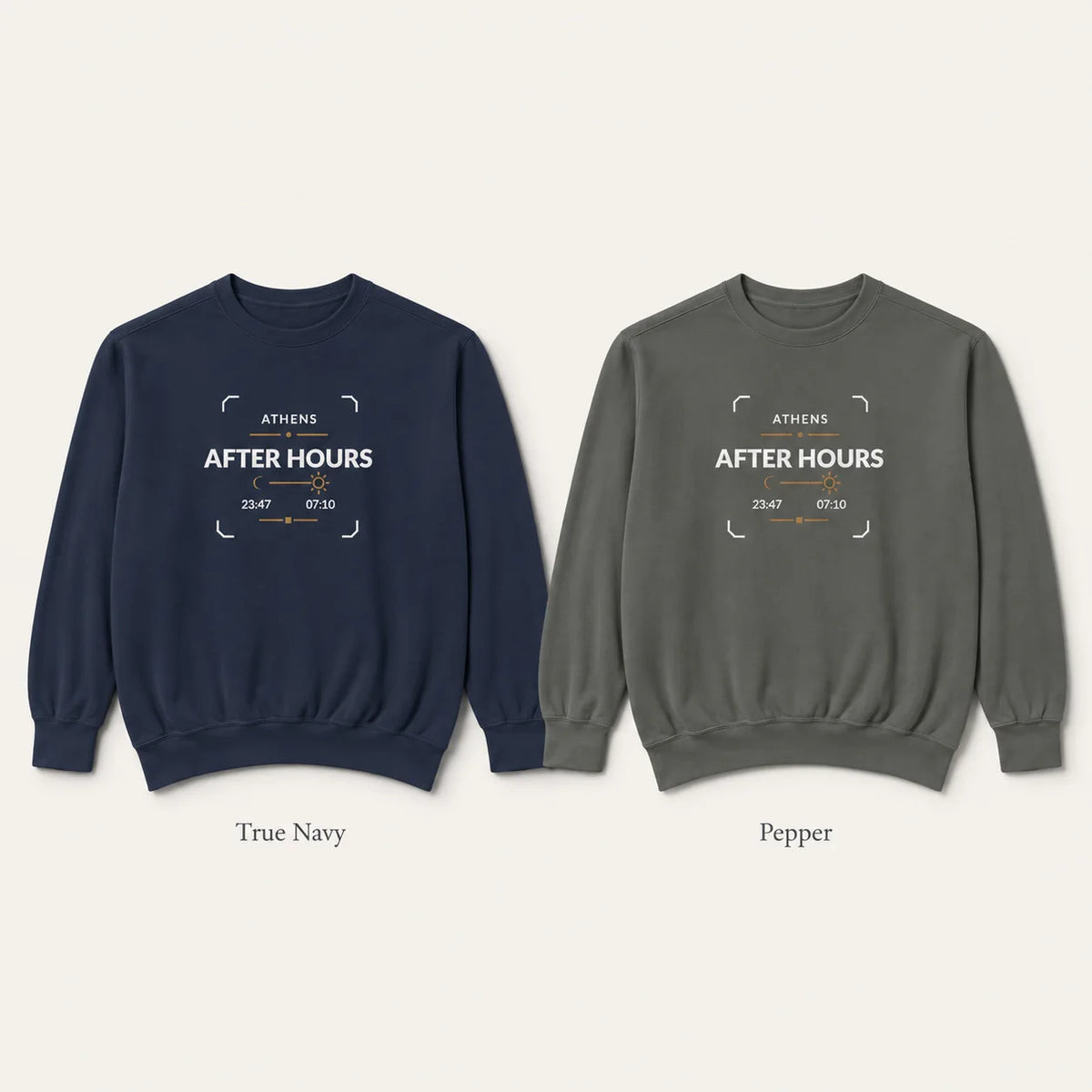 Two crewneck sweatshirts shown side by side on a light beige background. The left sweatshirt is navy blue and labeled 'True Navy', and the right sweatshirt is a muted gray-green and labeled 'Pepper'.