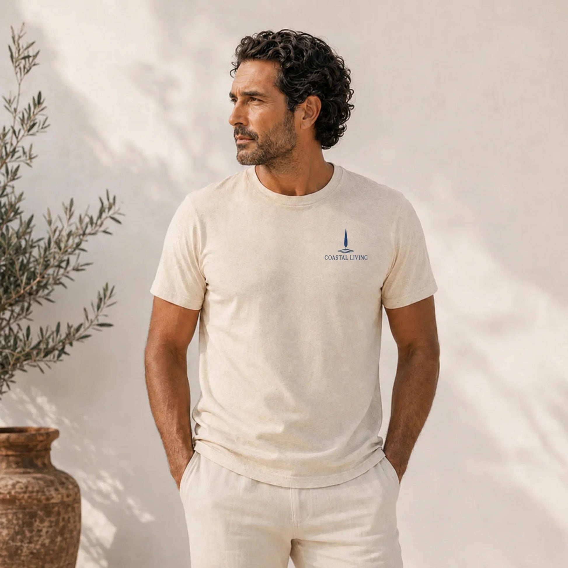 Man wearing a t-shirt with 'Coastal Living Mediterranean State of Mind' design.