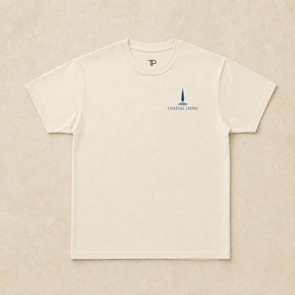 Flat lay of natural t-shirt with 'Coastal Living' design