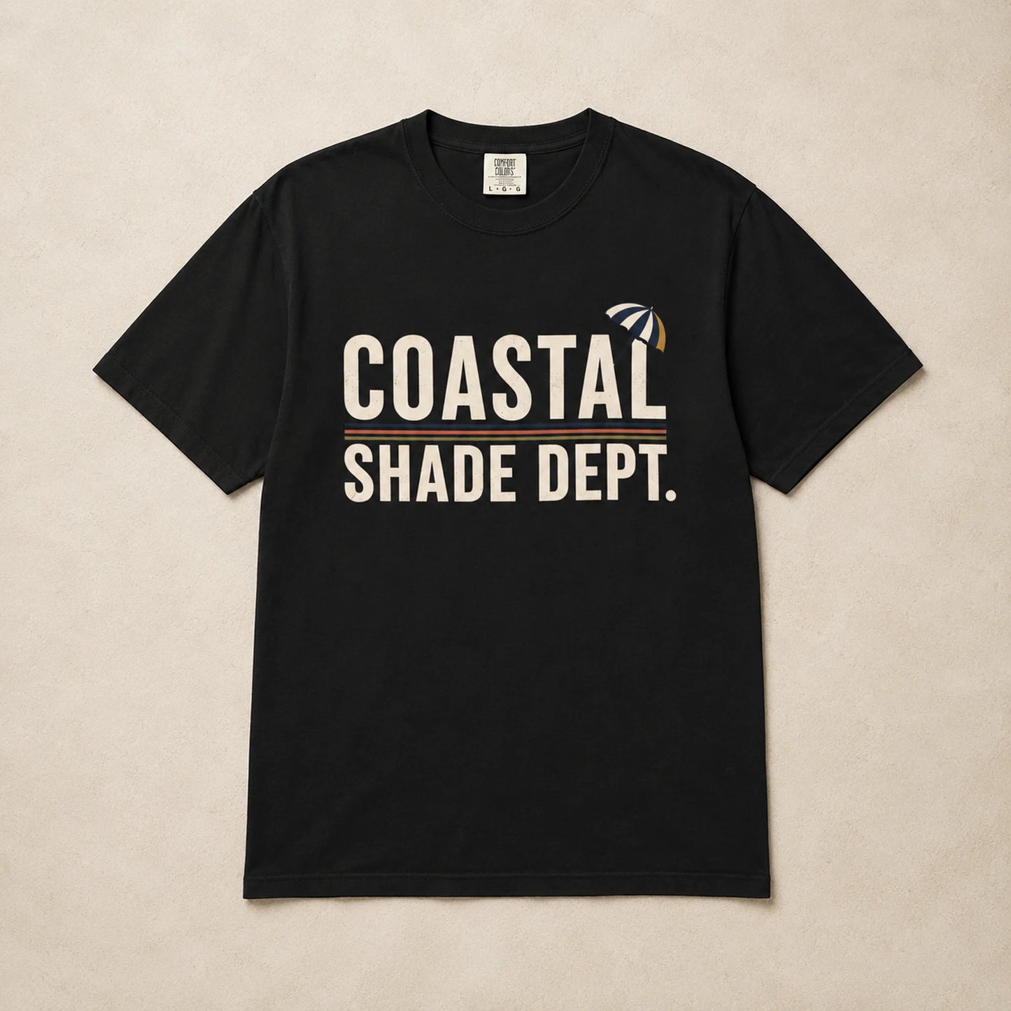 Black Coastal Shade Dept graphic T-shirt laid flat with cream lettering and retro stripe detail
