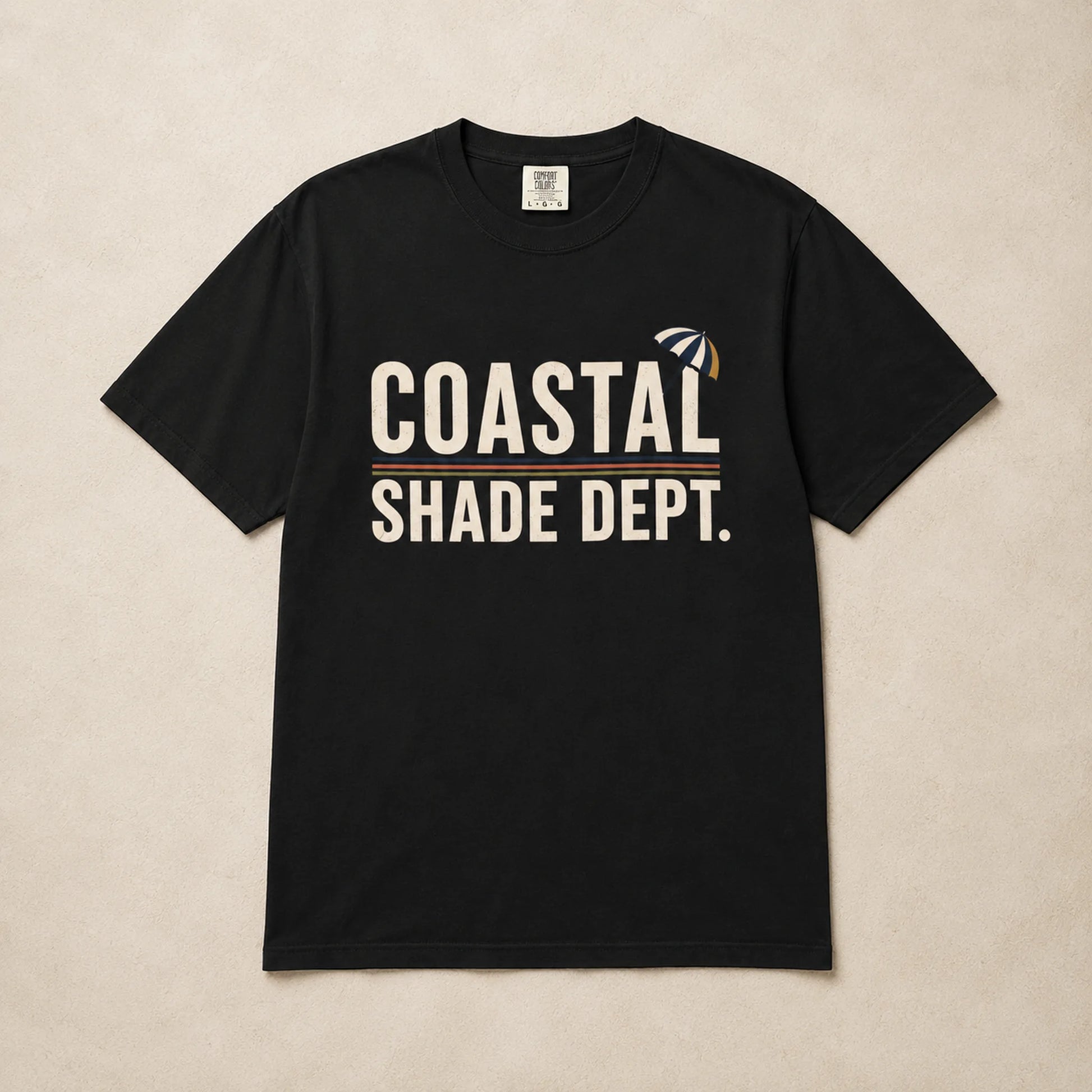 Black Coastal Shade Dept graphic T-shirt laid flat with cream lettering and retro stripe detail