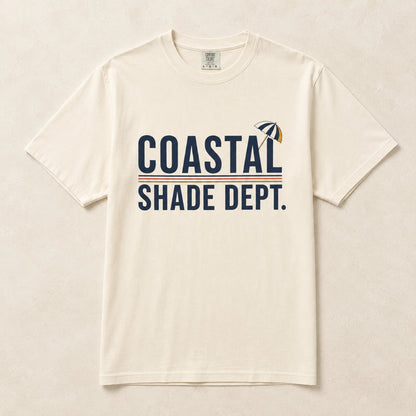 Ivory Coastal Shade Dept graphic T-shirt laid flat with retro beach umbrella artwork