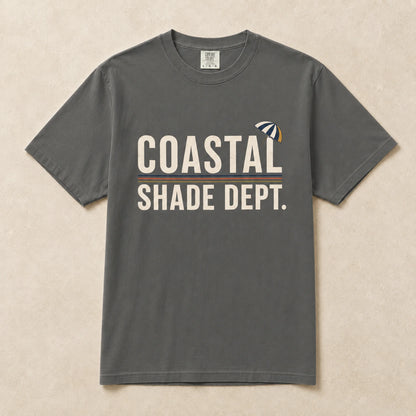 Charcoal Coastal Shade Dept graphic T-shirt laid flat with retro seaside umbrella graphic