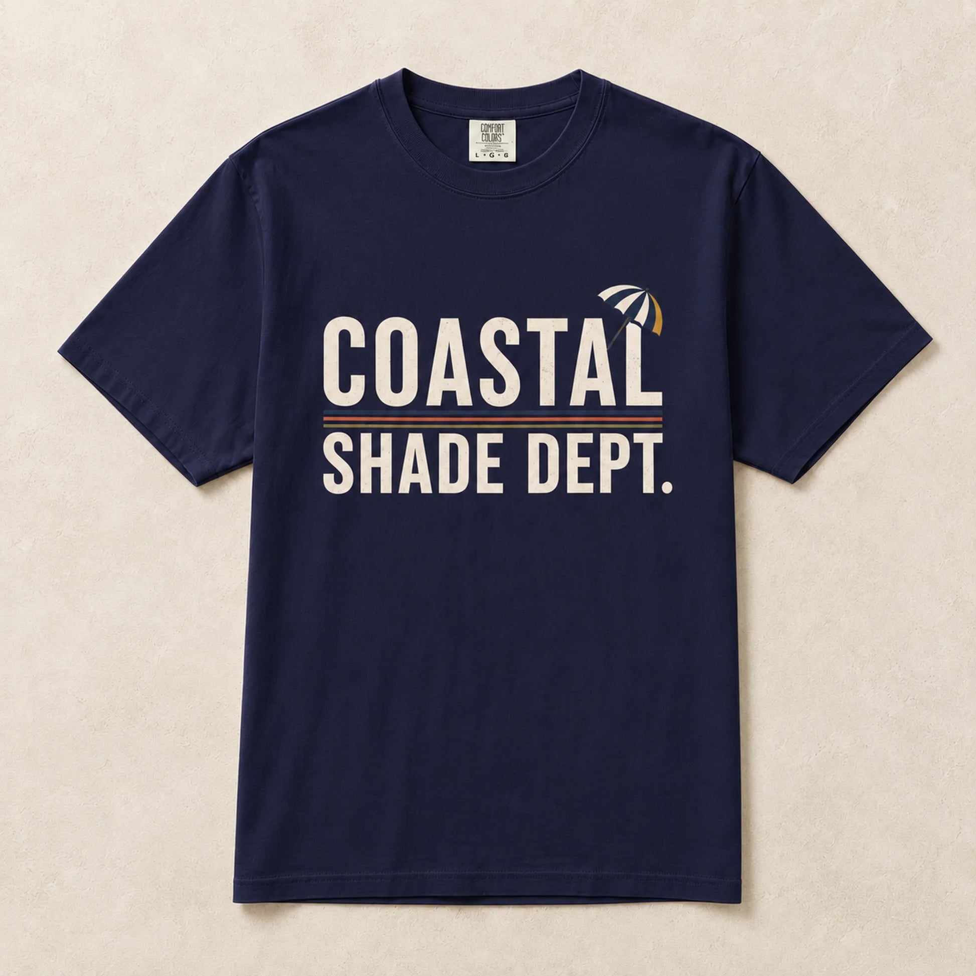 Navy Coastal Shade Dept graphic T-shirt laid flat with vintage beach-inspired print