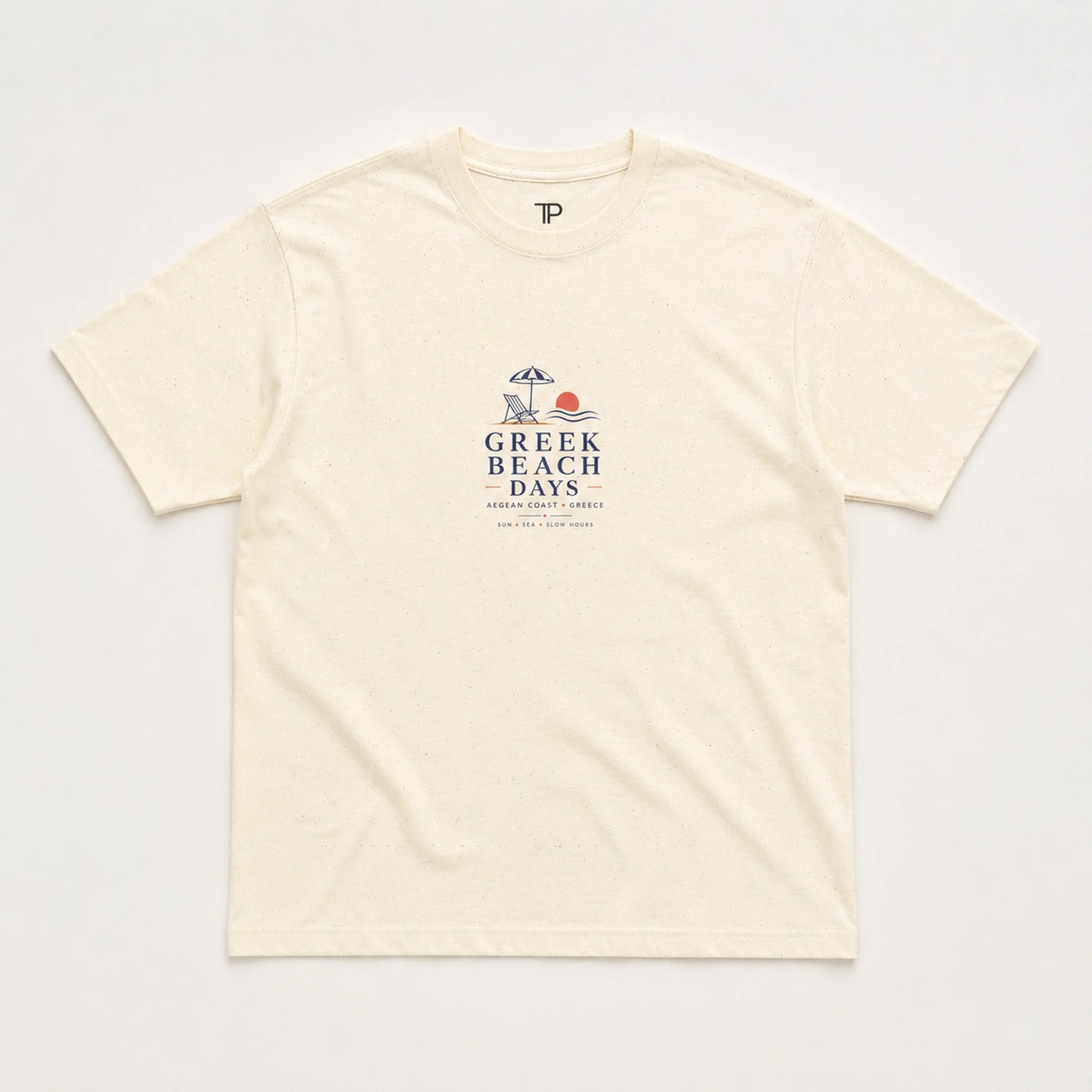 An off-white short-sleeve crewneck t-shirt with a 'Greek Beach Days' graphic printed on the chest, laid flat against a light background.