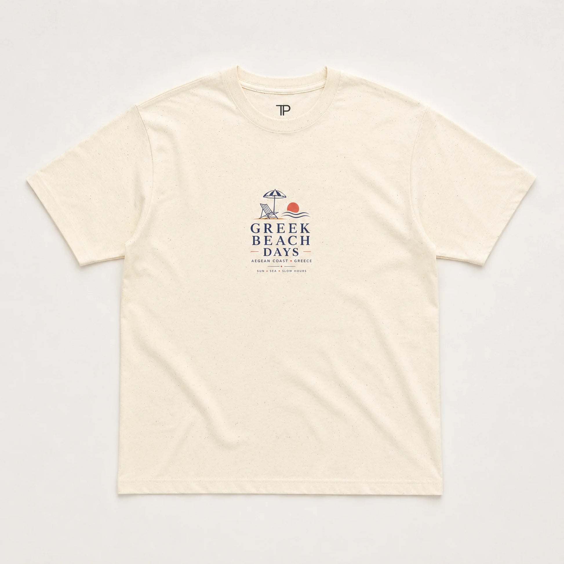 An off-white short-sleeve crewneck t-shirt with a 'Greek Beach Days' graphic printed on the chest, laid flat against a light background.