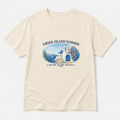 A cream-colored short-sleeve t-shirt with a graphic print on the front depicting a Greek island summer scene with a white building, blue sea, and a peacock, accompanied by the text 'GREEK ISLAND SUMMER' and 'ESCAPE TO THE AEGEAN'.