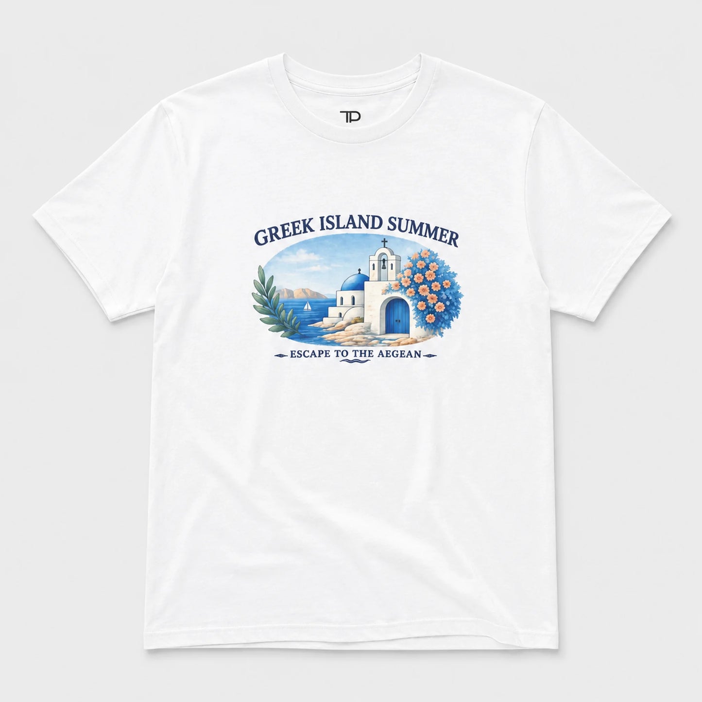 A white short-sleeve crewneck t-shirt featuring a colorful graphic print on the front. The graphic depicts a Greek island scene with a white building, blue domes, a blue arched doorway, green palm leaves, and blue peonies, framed by the text 'GREEK ISLAND SUMMER' and 'ESCAPE TO THE AEGEAN'.