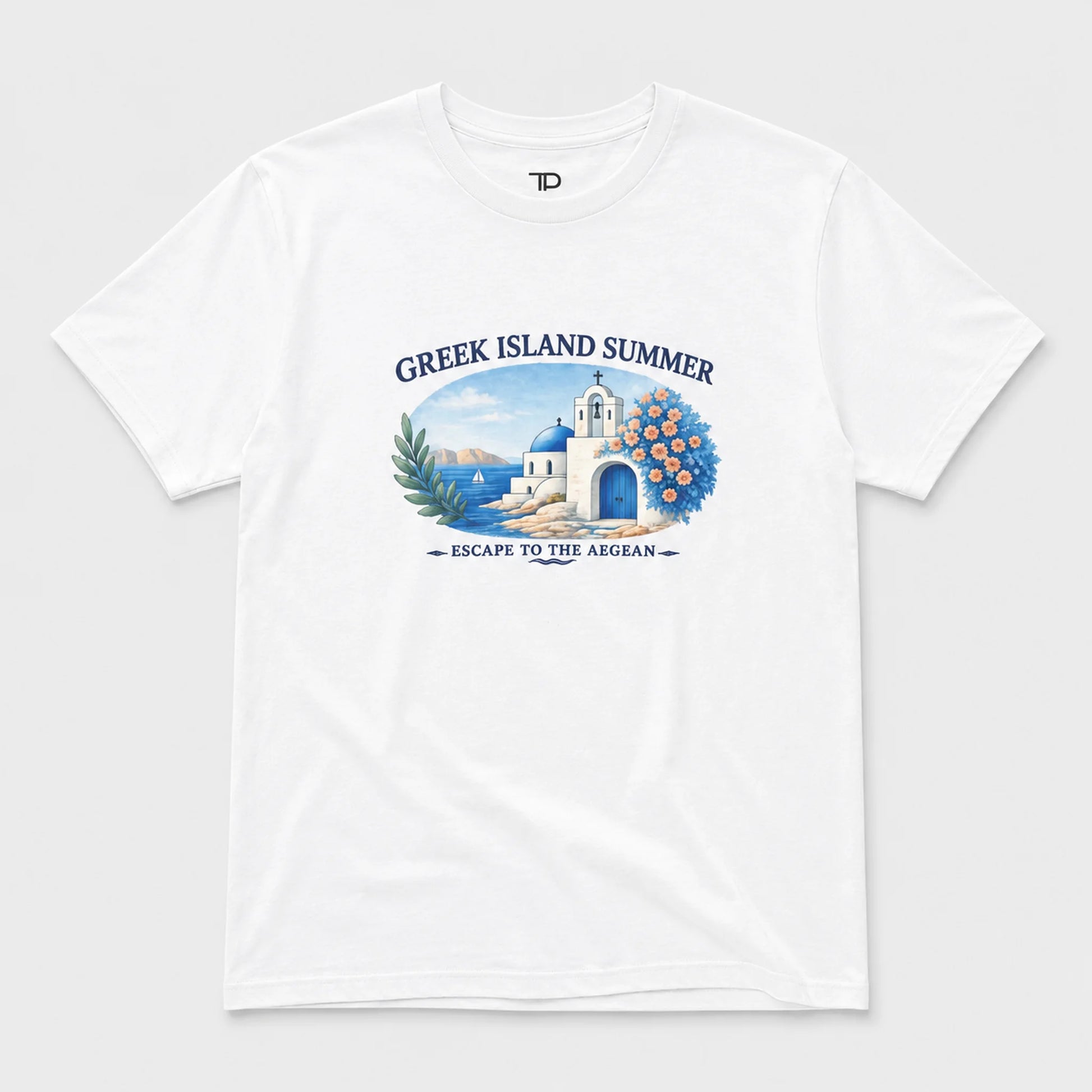 A white short-sleeve crewneck t-shirt featuring a colorful graphic print on the front. The graphic depicts a Greek island scene with a white building, blue domes, a blue arched doorway, green palm leaves, and blue peonies, framed by the text 'GREEK ISLAND SUMMER' and 'ESCAPE TO THE AEGEAN'.