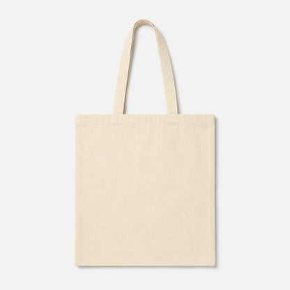 A plain canvas tote bag in a light cream or off-white color, featuring two long shoulder straps, shown against a solid light gray background.
