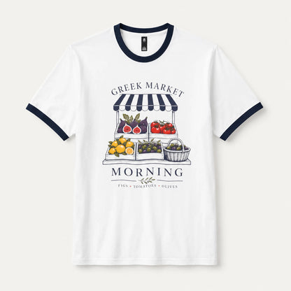 A white ringer t-shirt with navy blue trim on the crew neck and sleeve cuffs, featuring a graphic print of a Greek market fruit and vegetable stand with the text 'GREEK MARKET MORNING'.