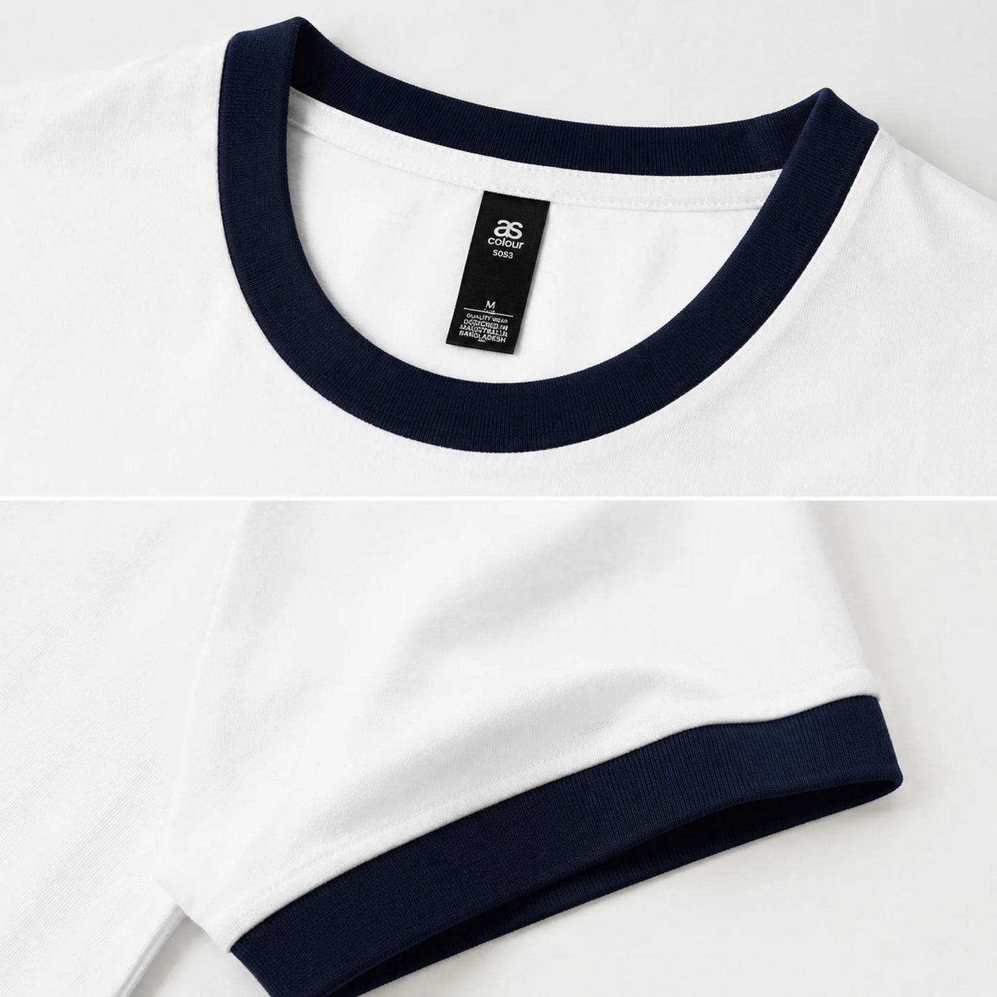 Close-up of a white ringer T-shirt with dark navy blue ribbed collar and sleeve cuff, showing the inner neck label.
