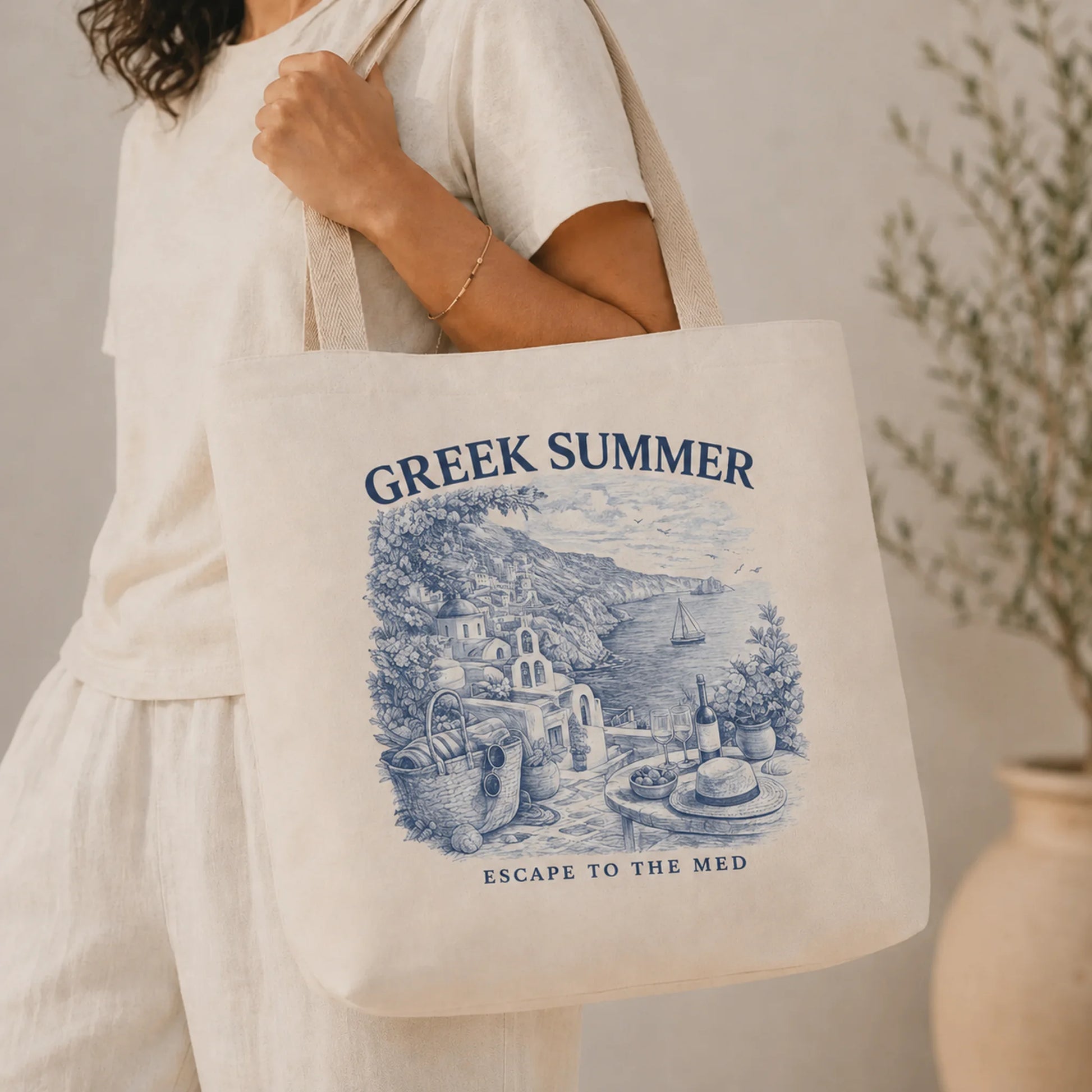 TP HERO: Person holding a tote bag with 'Greek Summer' design and text.