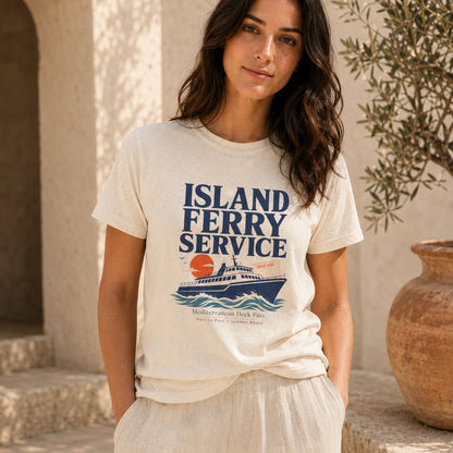 A woman wearing a cream-colored graphic t-shirt with a blue and orange 'Island Ferry Service' print, standing in a sunlit stone courtyard next to a large terracotta pot.