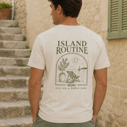 Man wearing a t-shirt with 'Island Routine' design standing on stone steps.