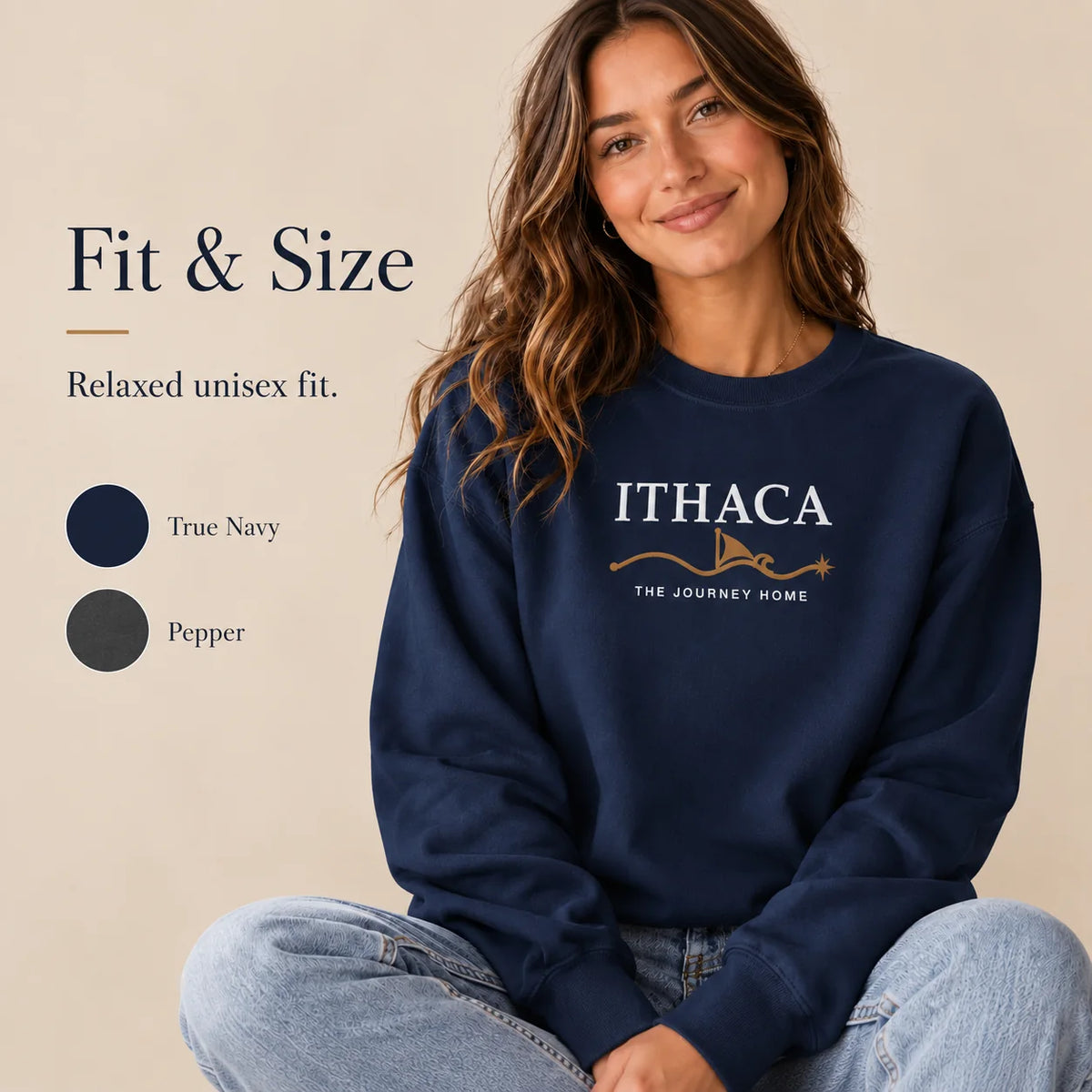 A woman wearing a navy crewneck sweatshirt with 'ITHACA THE JOURNEY HOME' embroidered on the chest, seated against a beige background. The image includes 'Fit & Size' text and color swatches for 'True Navy' and 'Pepper'.