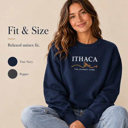 A woman wearing a navy crewneck sweatshirt with 'ITHACA THE JOURNEY HOME' embroidered on the chest, seated against a beige background. The image includes 'Fit & Size' text and color swatches for 'True Navy' and 'Pepper'.