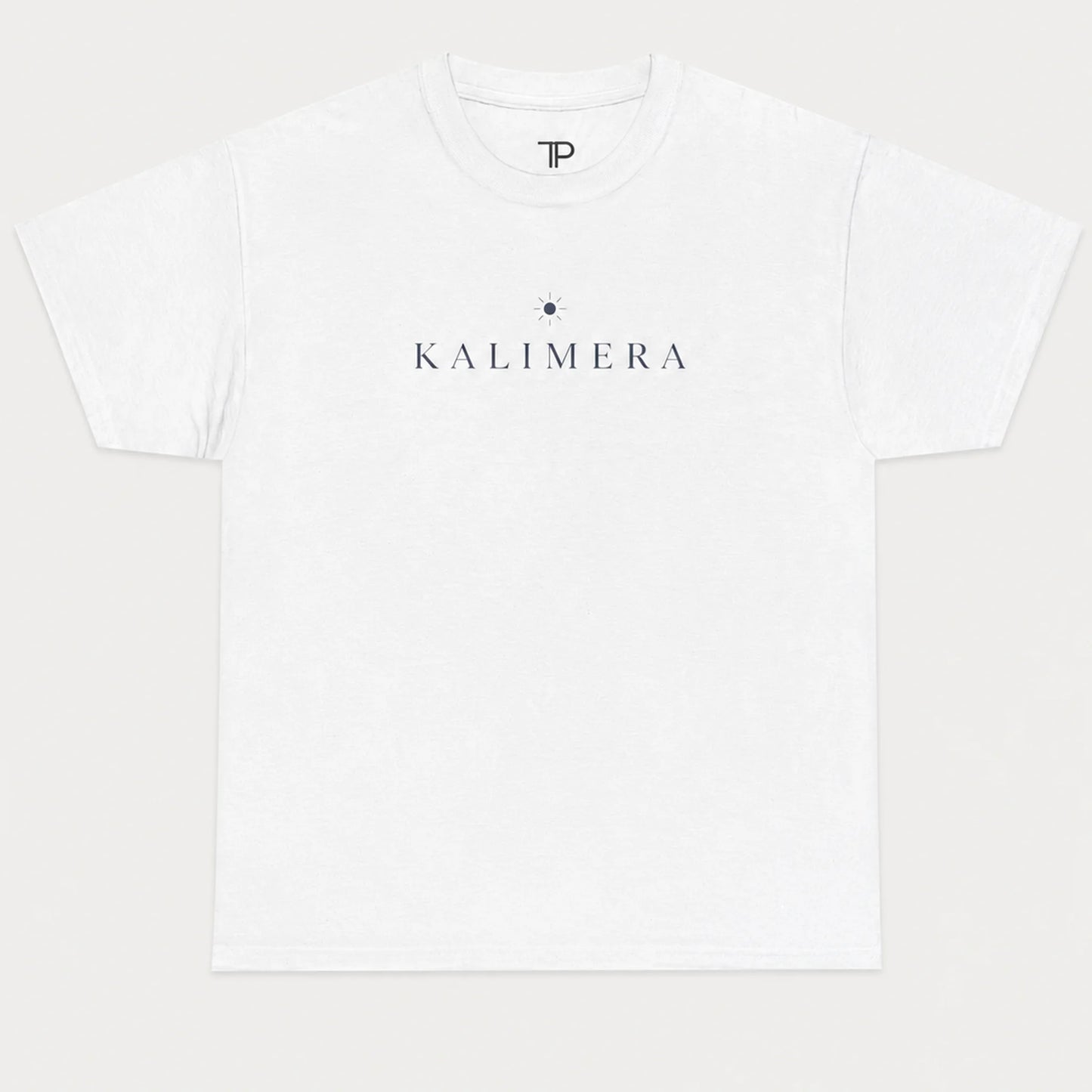 A white short-sleeve crewneck t-shirt with 'KALIMERA' printed in navy blue across the chest, flanked by a small navy star graphic, shown on a light gray background.