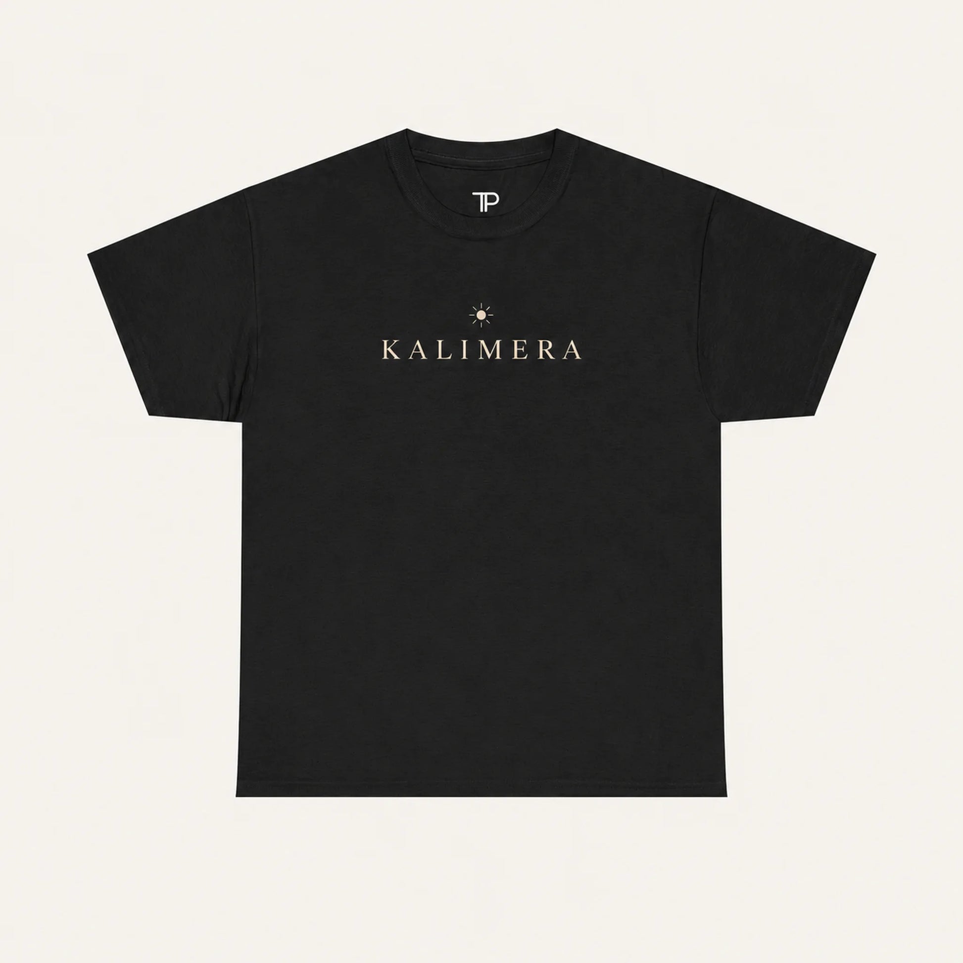 A black short-sleeve crewneck t-shirt with 'KALIMERA' printed in gold across the chest, accompanied by a small gold star graphic, shown against a light cream background.