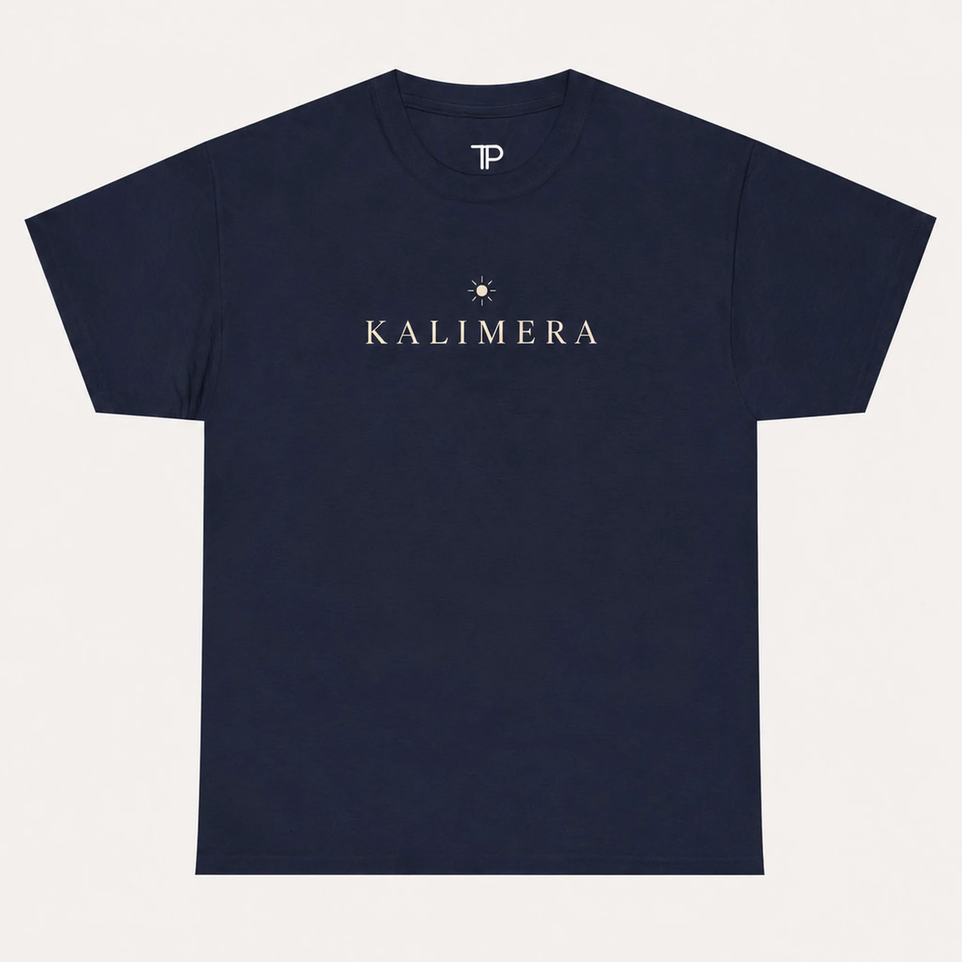 A navy blue short-sleeve crewneck t-shirt with 'KALIMERA' printed in gold on the chest, accompanied by a small gold sun graphic. The inner neck features a white 'TP' logo.