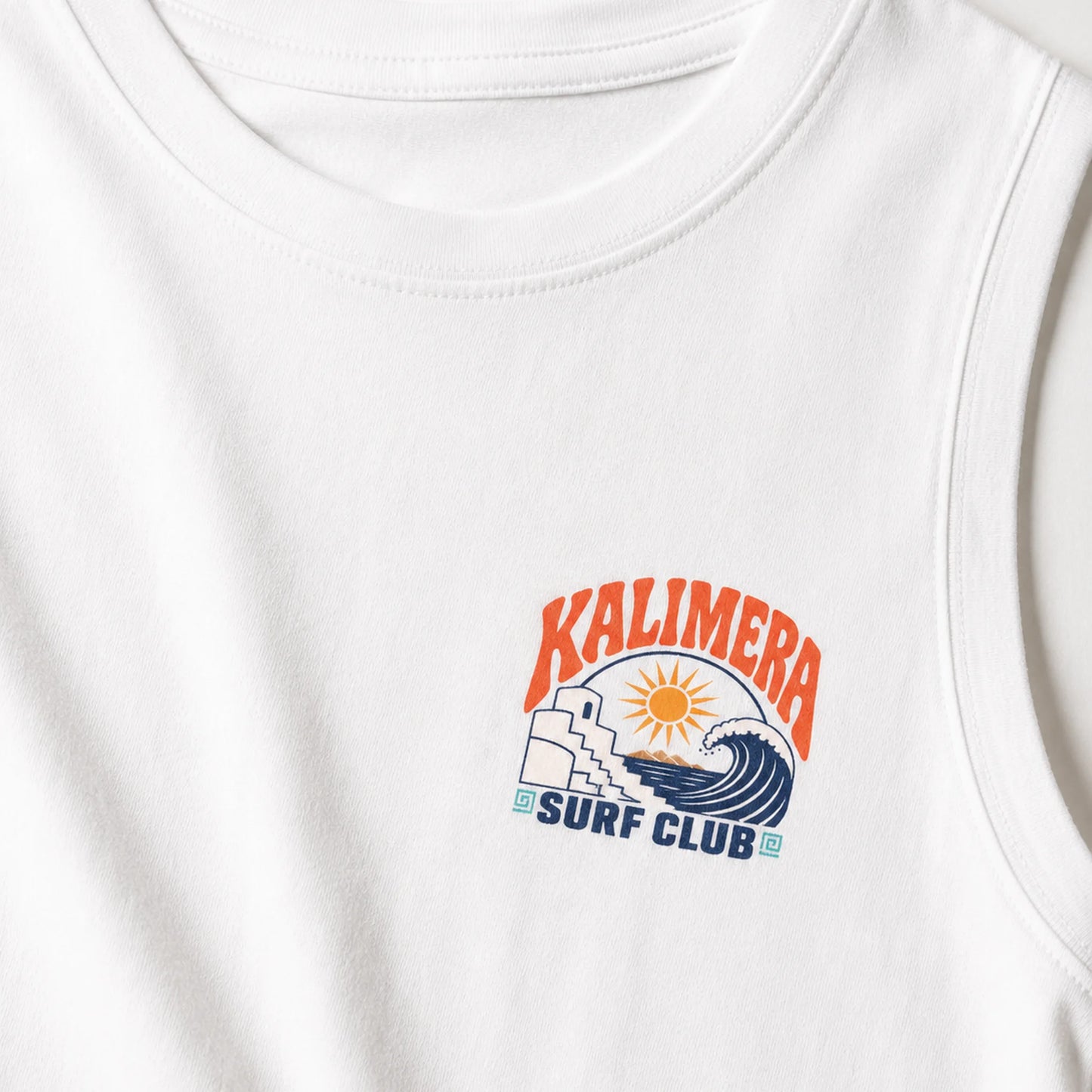Close-up of a white sleeveless tank top showing the chest area with a colorful graphic that reads 'KALIMERA SURF CLUB' above an illustration of a wave, sun, and stairs.