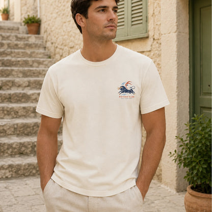 Man wearing a white t-shirt with a logo standing on stone steps.