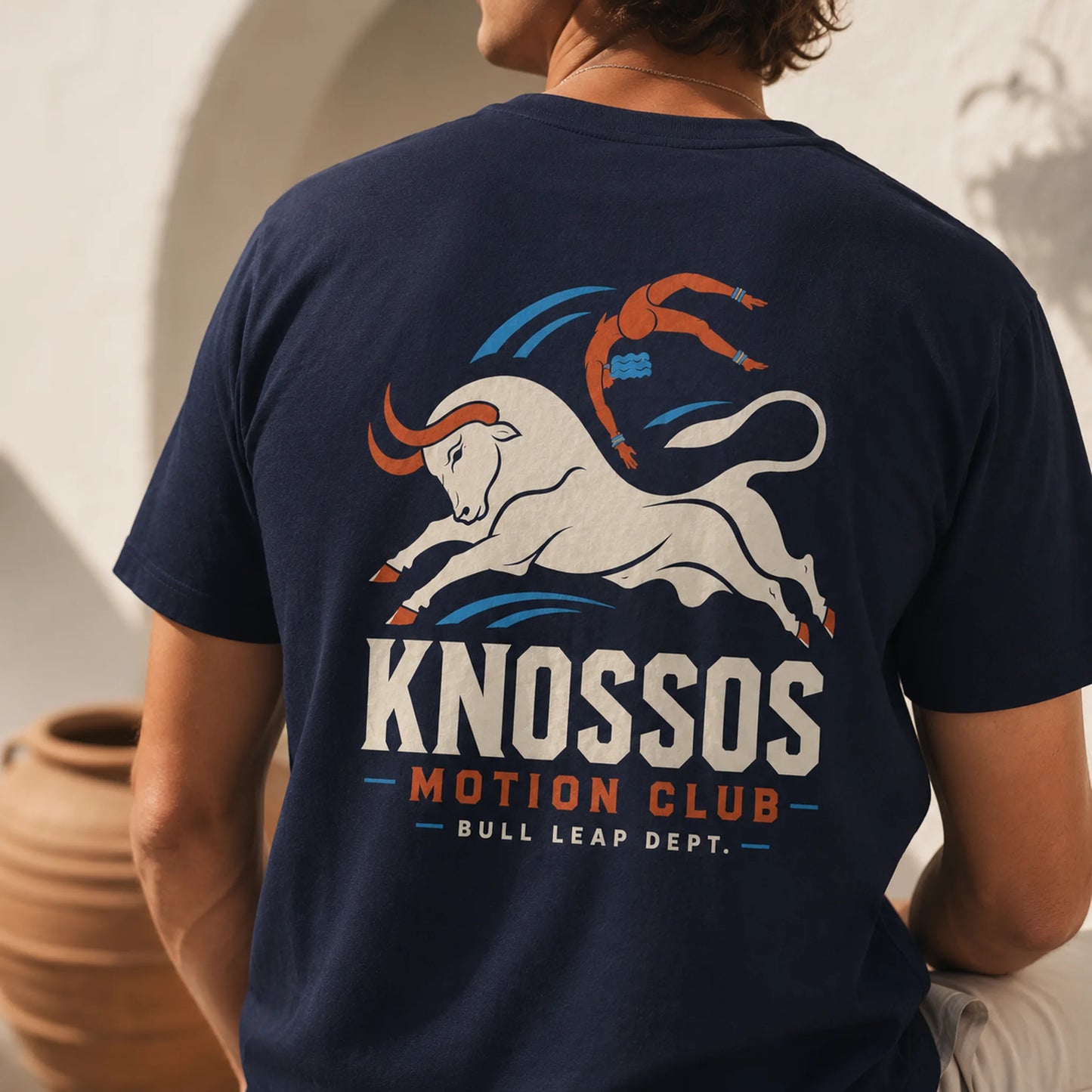 Person wearing a navy blue t-shirt with a bull graphic and text on the back.
