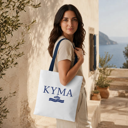 Woman holding a KYMA tote bag with a scenic background
