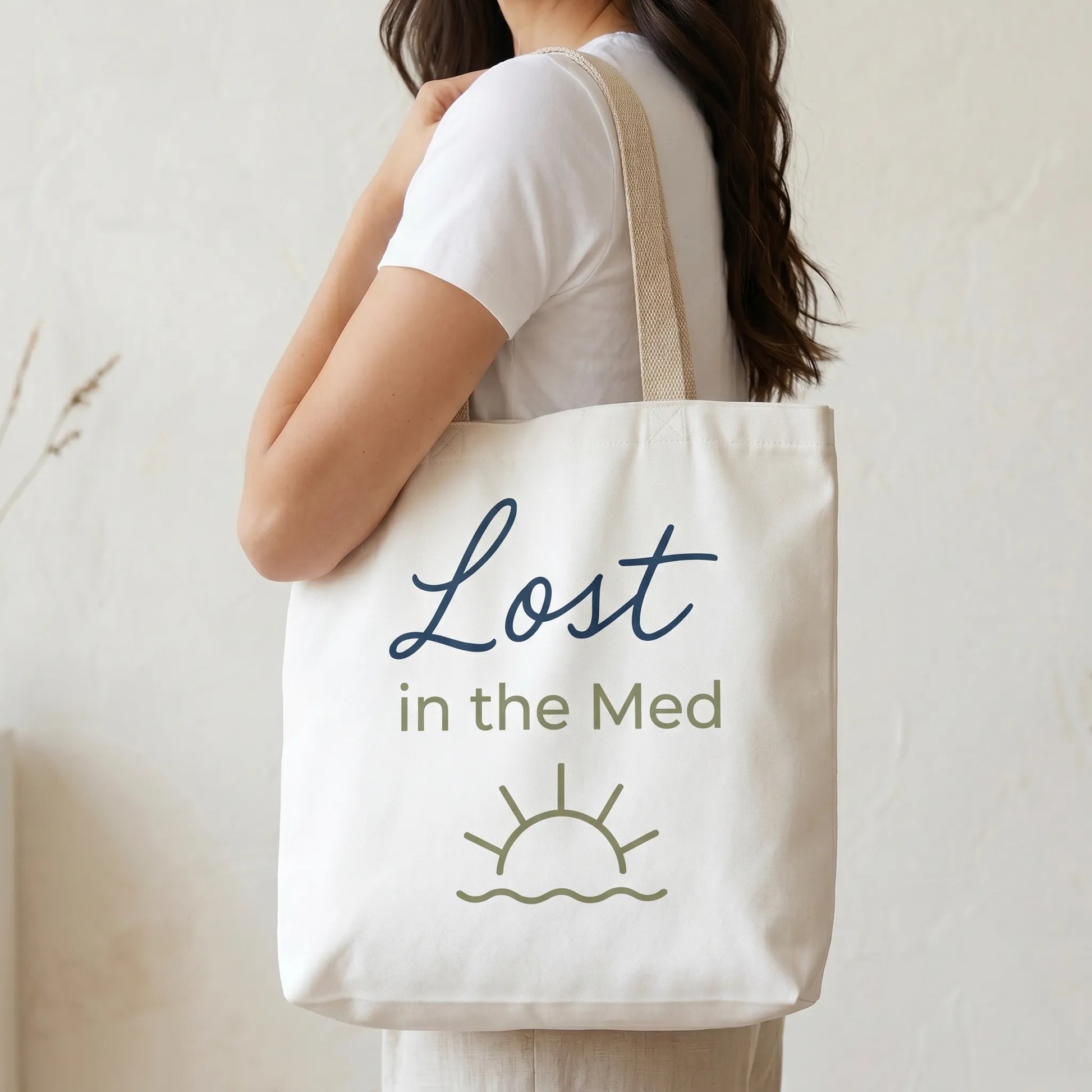TP HERO: Person holding a tote bag with 'Lost in the Med' text and sun graphic.