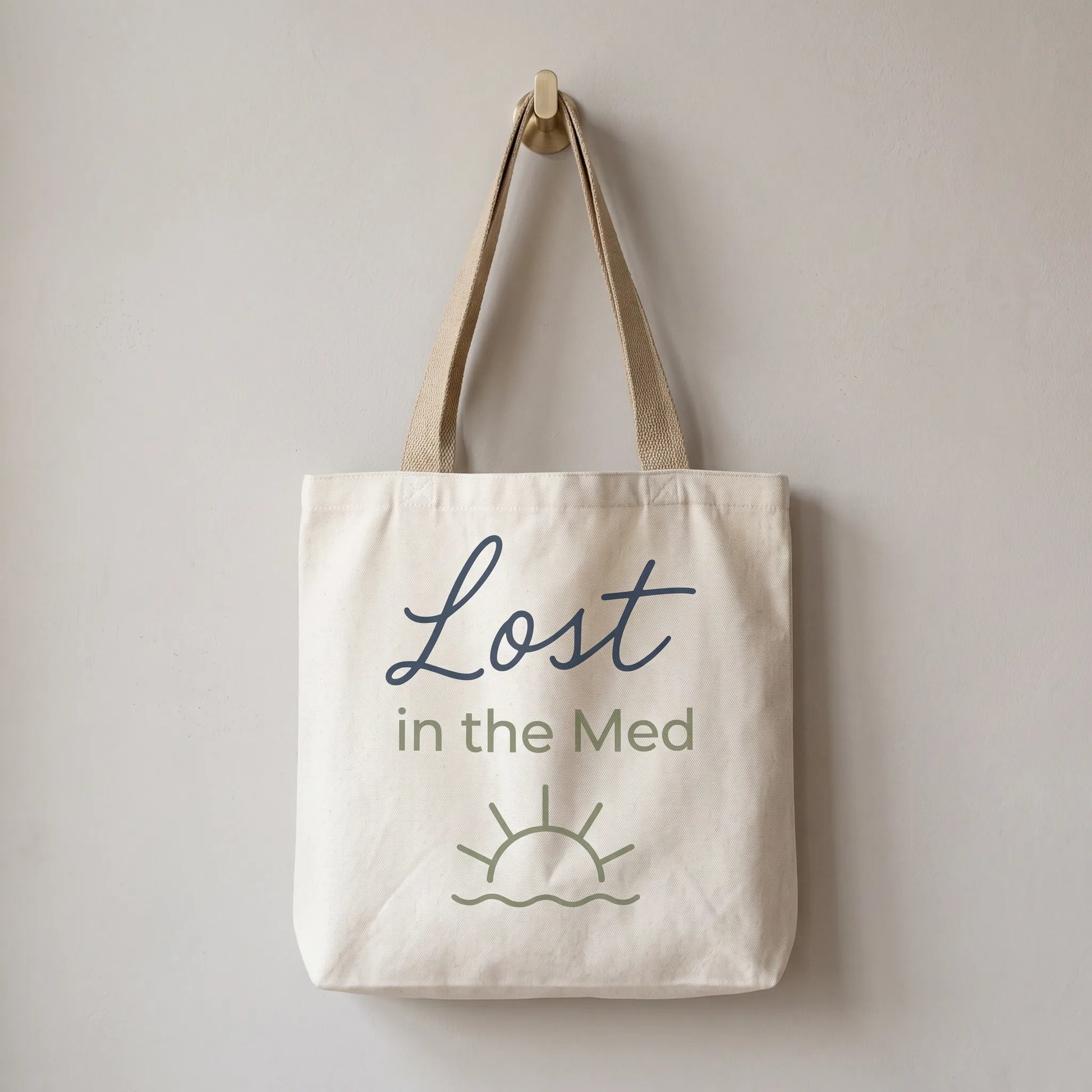 Tote bag with 'Lost in the Med' text on a plain background