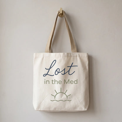 Tote bag with 'Lost in the Med' text on a plain background