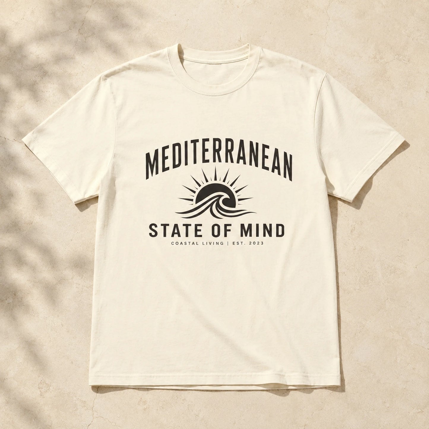 White t-shirt with 'Mediterranean State of Mind' design on a beige background