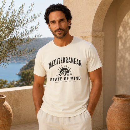 Man wearing a 'Mediterranean State of Mind' t-shirt with a scenic background.