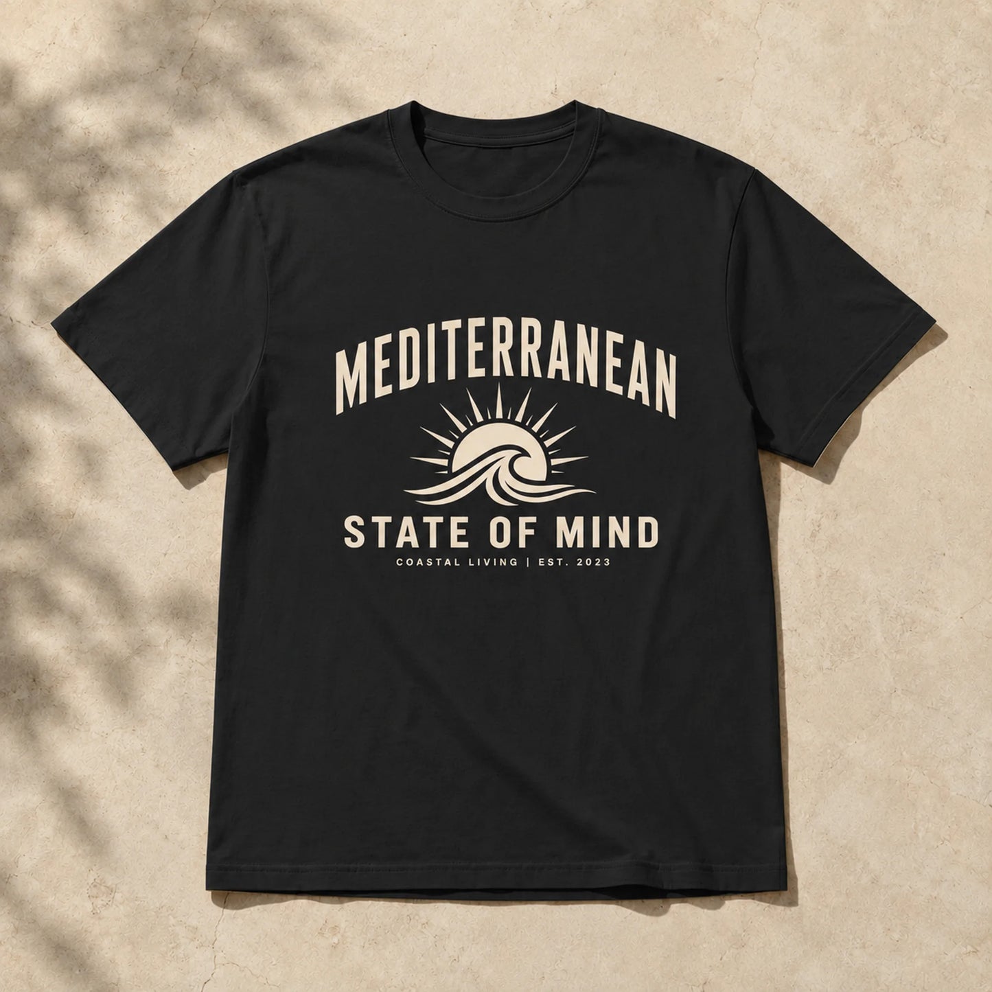 Black t-shirt with 'Mediterranean State of Mind' design on a beige background